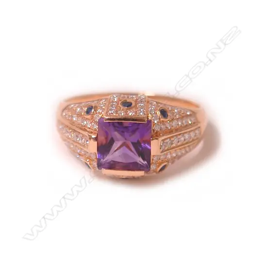 A modern 18ct. rose gold amethyst and diamond dress ring