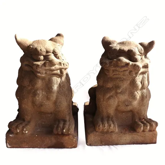 A pair of stoneware foo dogs