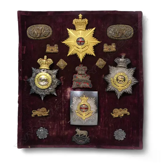 A collection of Victorian military helmet plates and insignia etc. pertaining to the Wyndowe family,