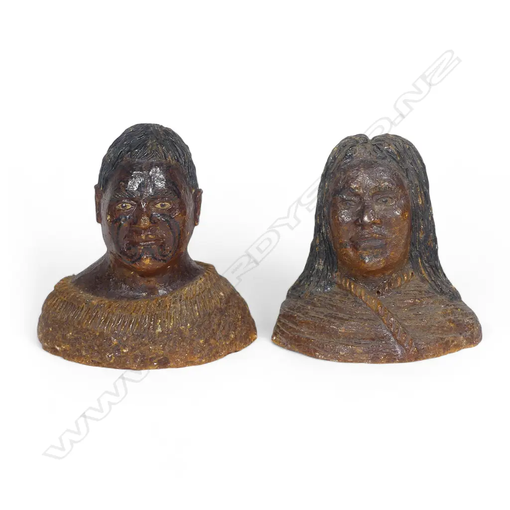 A pair of late 19thC large carved kauri gum busts of a Māori chief and chieftainess, naturalistically represented with black staining to their hair and moko, both represented with a muku cloak wrapped to their shoulders. Minor chipping to edges. H's.105mm. Provenance: From the John Perry estate. Image 1++