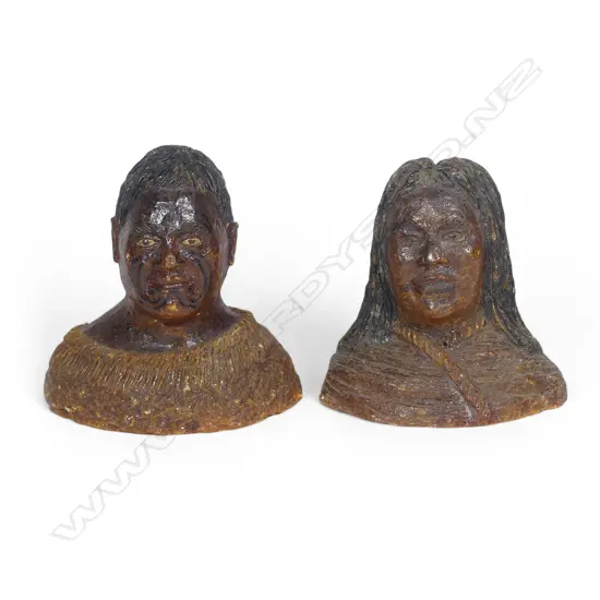 A pair of late 19thC large carved kauri gum busts of a Māori chief and chieftainess, naturalistically represented with black staining to their hair and moko, both represented with a muku cloak wrapped to their shoulders. Minor chipping to edges. H's.105mm. Provenance: From the John Perry estate.