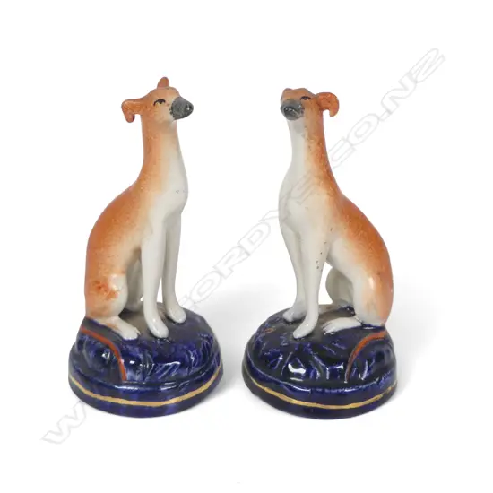 A pair of Victorian Staffordshire small seated hounds,