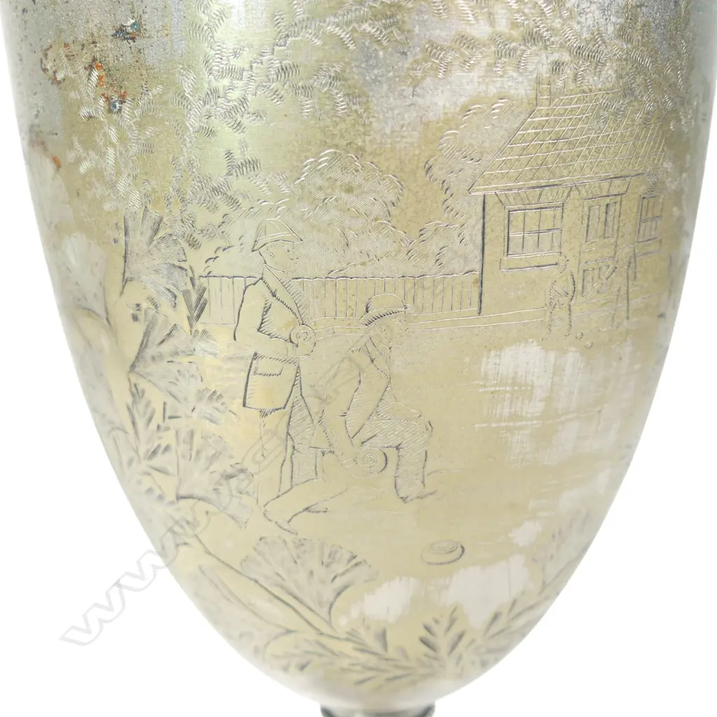 A late 19thC New Zealand historical silver plate trophy cup, presentation engraved ' Dunedin Bowling Club Rink Match 1887 Won By James Anderson. The front engraved with a bowling scene. The plating worn. H.210mm. Image 1++