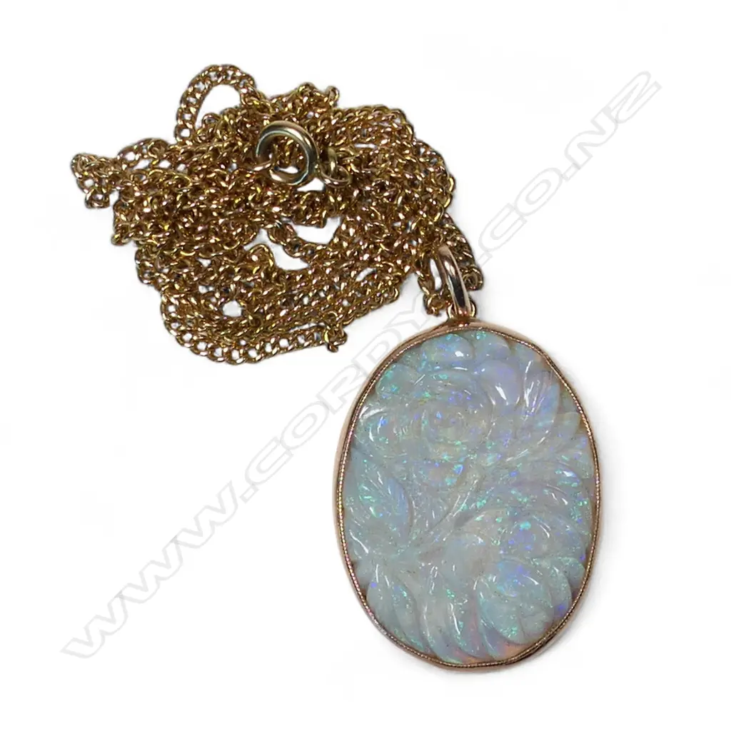 A 9ct gold framed carved large opal panelled pendant on 9ct gold chain, Image 1++