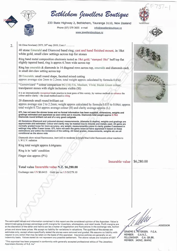 An 18ct white gold emerald and diamond dress ring, Image 1++