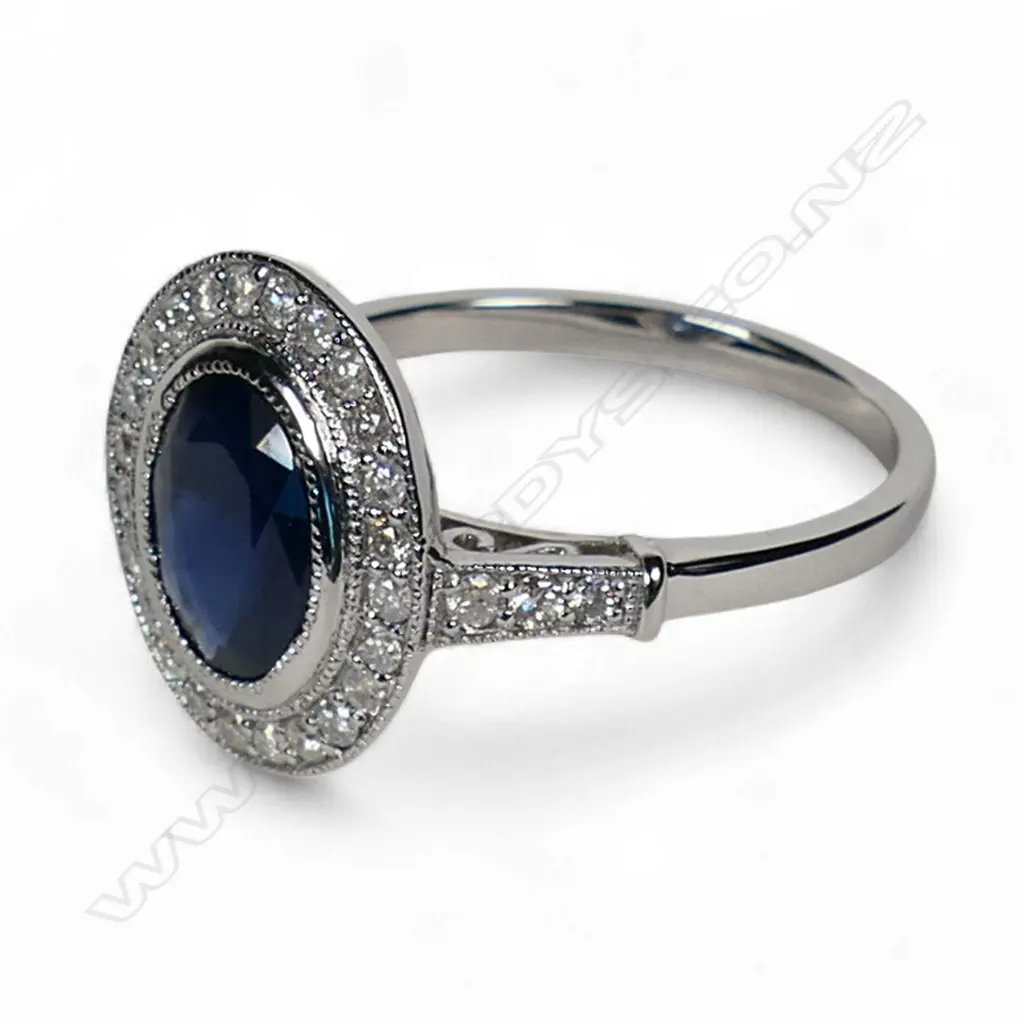 A 14ct white gold sapphire and diamond halo ring, Image 1++