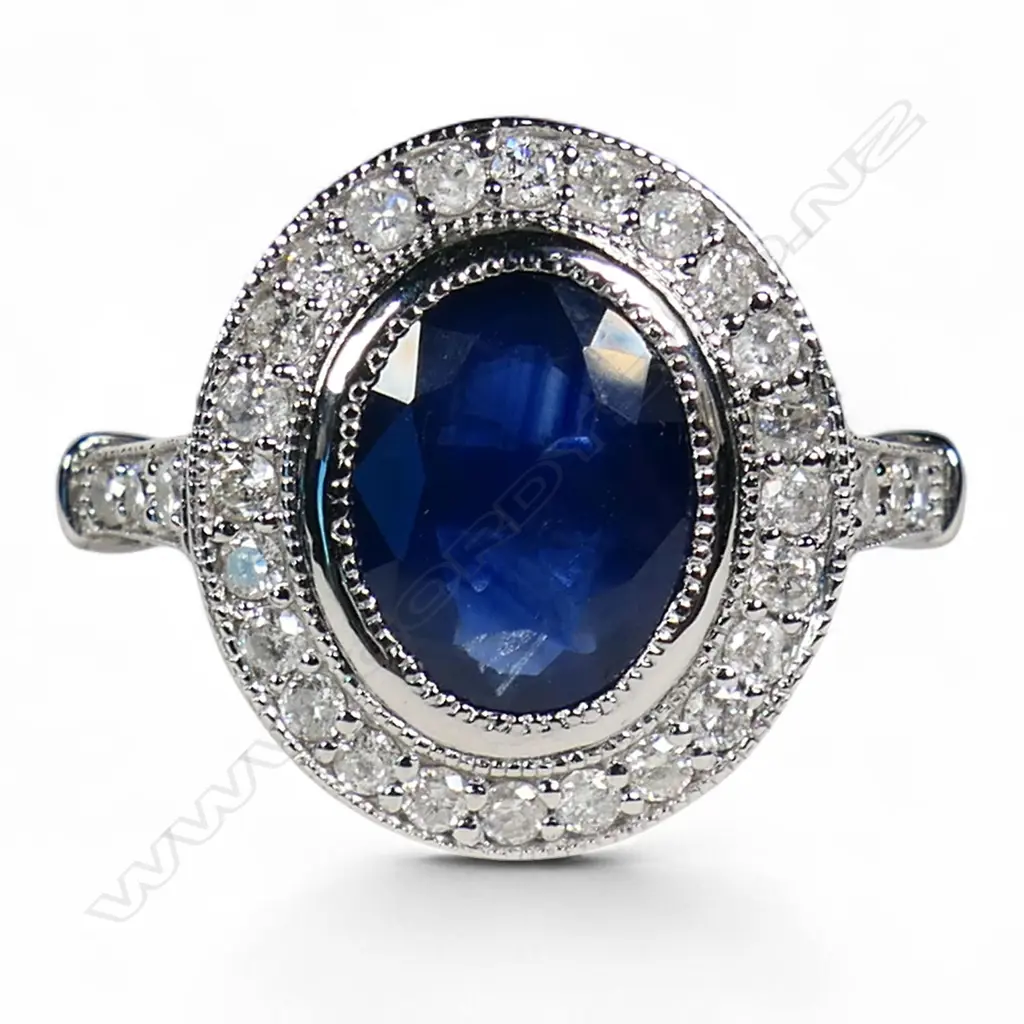 A 14ct white gold sapphire and diamond halo ring, Image 1++