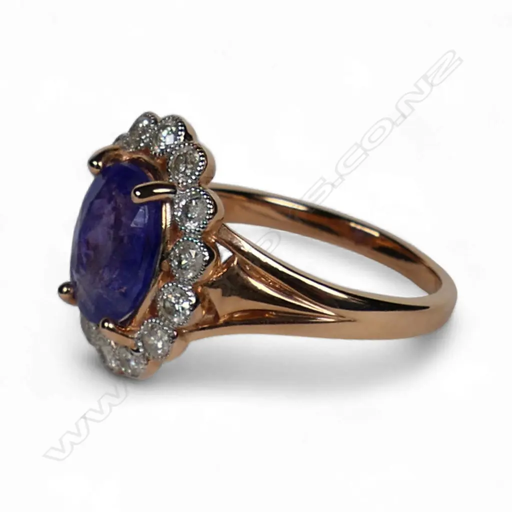 A 14ct rose gold tanzanite and diamond halo ring, Image 1++