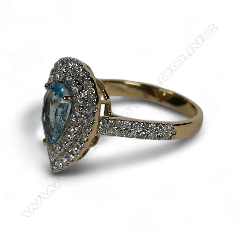 A 14ct gold aquamarine and diamond double halo ring, Image 1++