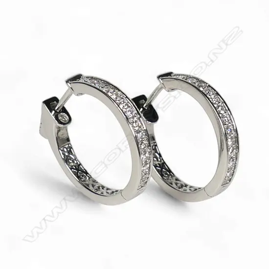 A pair of platinum and diamond hoop earrings,