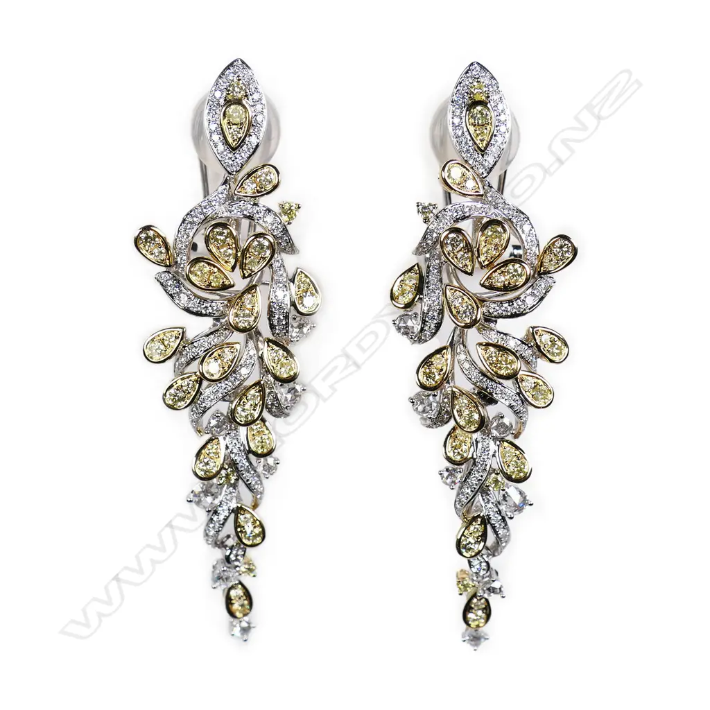 A pair of white and yellow gold diamond earrings, Image 1++