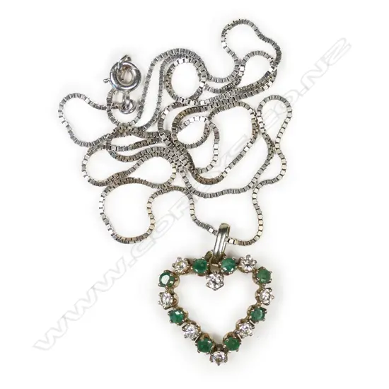 An 18ct white gold diamond and emerald pendant,
