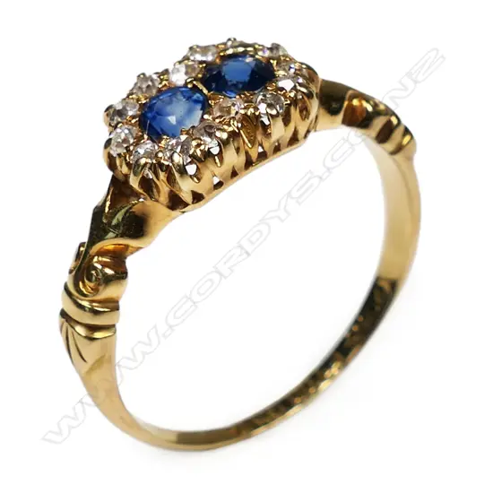 An 18ct yellow gold two sapphire and diamond cluster ring,