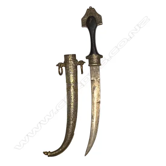 A Middle Eastern dagger - silvered brass heavily embossed scabbard, aged wooden handle and curved double edge blade. L.410mm.