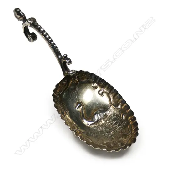 A Victorian silver tea caddy spoon - the large bowl embossed with a swan. The antique style handle with bead detailed and portrait head. London 1891 by Pairpoint Brothers.