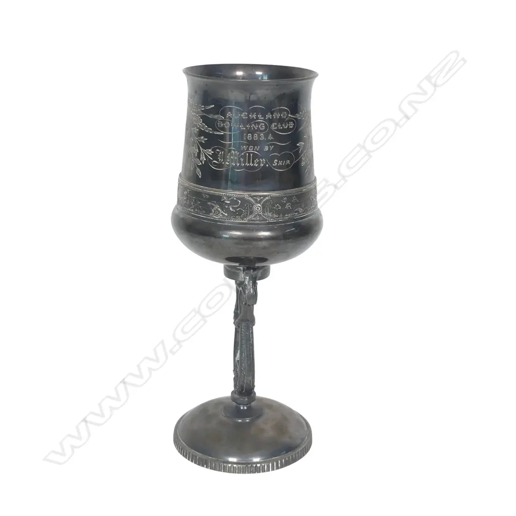 A late 19thC New Zealand historical silver plate trophy cup - presentation engraved ' Auckland Bowling Club 1883.4 Won By J Miller, Skip.'. The column support as a lyre. Tarnished. H.215mm. Image 1++