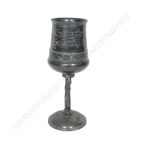 A late 19thC New Zealand historical silver plate trophy cup - presentation engraved ' Auckland Bowling Club 1883.4 Won By J Miller, Skip.'. The column support as a lyre. Tarnished. H.215mm.