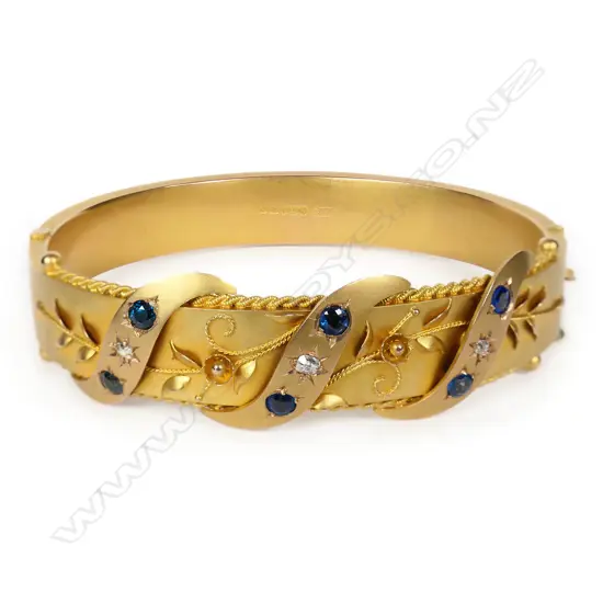 A Victorian 9ct gold diamond and sapphire hinged bangle,