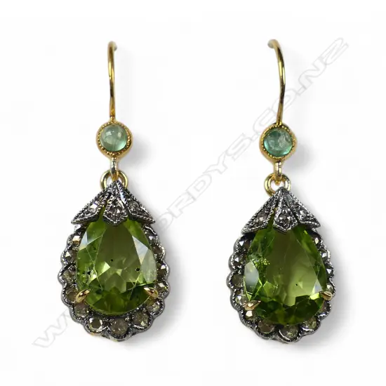 A pair of antique style silver gilt diamond peridot and emerald earrings,