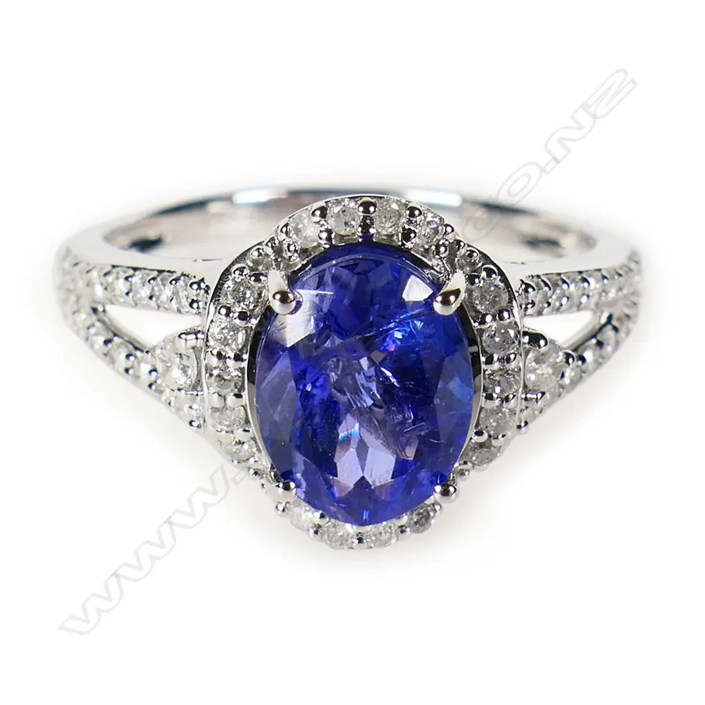 A 14ct white gold tanzanite and diamond halo ring, Image 1++