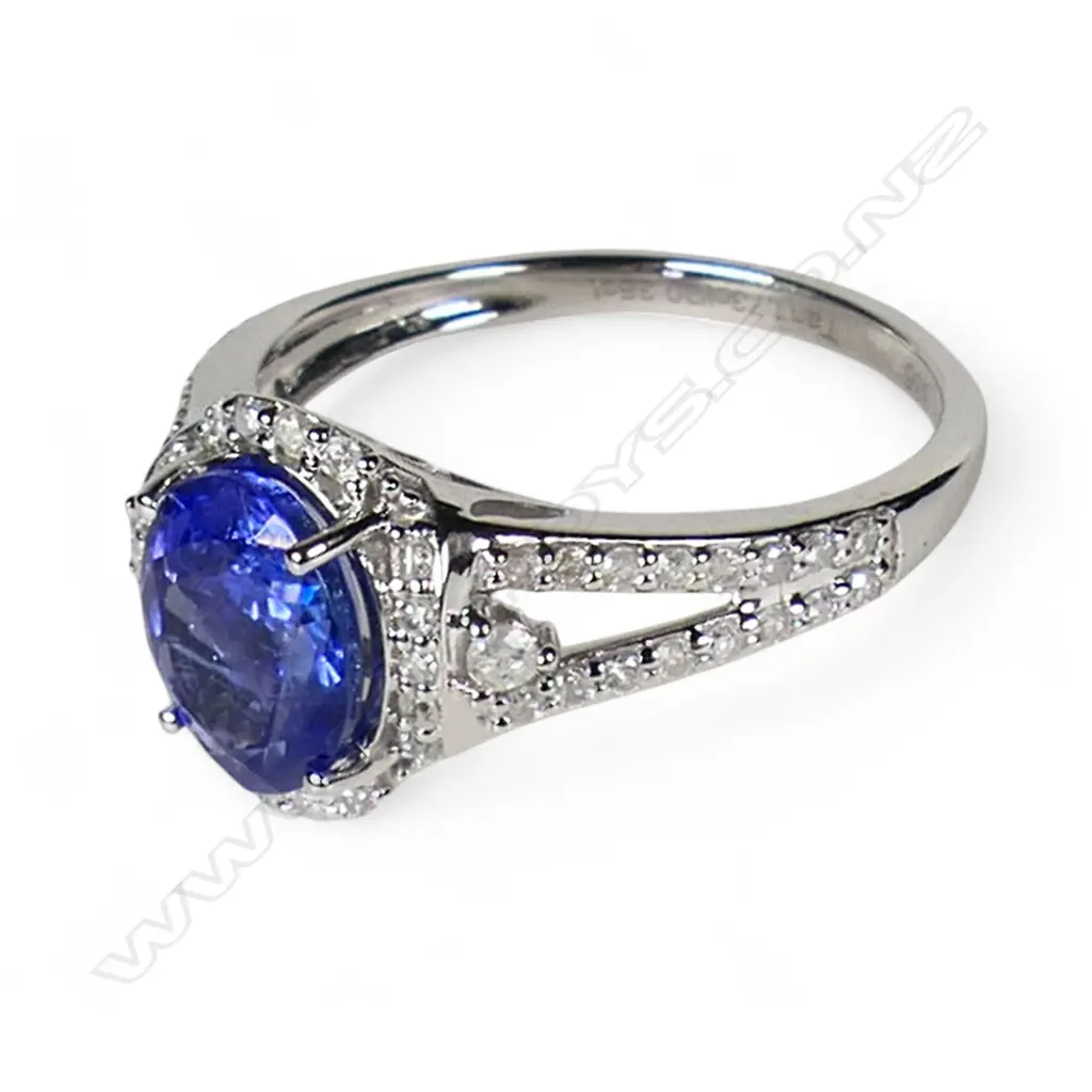 A 14ct white gold tanzanite and diamond halo ring, Image 1++