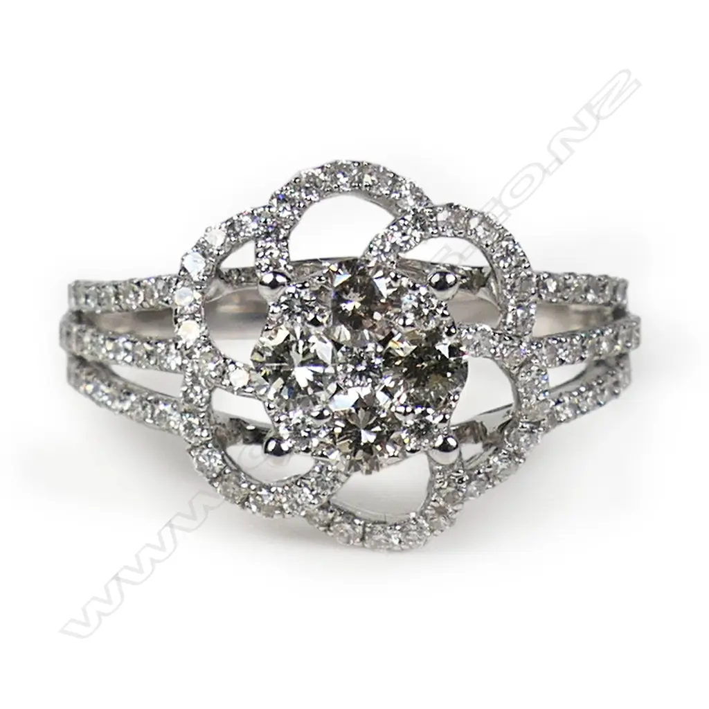 An 18ct white gold and diamond cluster ring, Image 1++