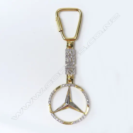 A diamond set 18ct gold Mercedes Benz key ring