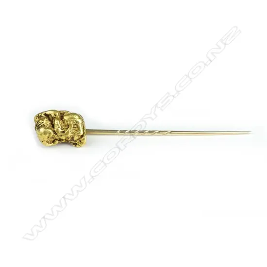 A gold stick pin