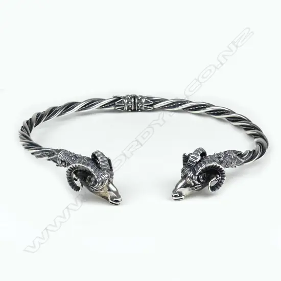 A silver rams head 'torque'