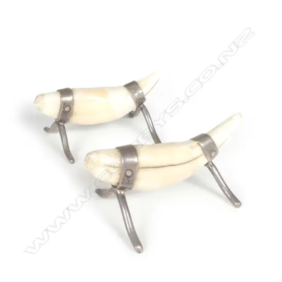 A pair of c.1900 leopard's teeth and silver mounted knife rests