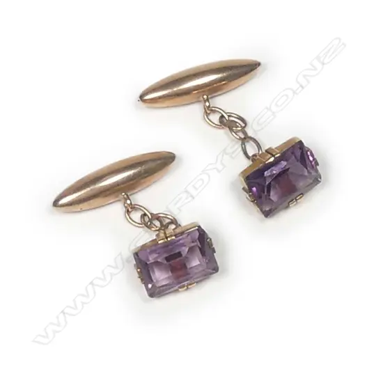 A pair of early 20thC 9ct. rose gold and amethyst cufflinks