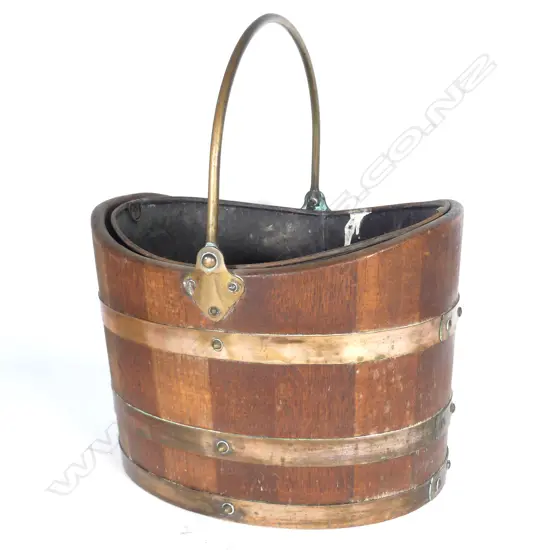 A coopered coal scuttle with copper binding and handle
