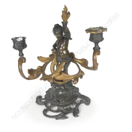 A good 19thC French bronze and gilt cherub figured table candelabra
