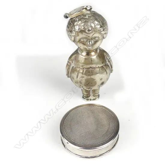 A sterling silver pill box and a 1920s silver plated baby's rattle