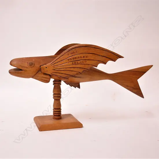 An old Pitcairn Island carved wood flying fish on stand