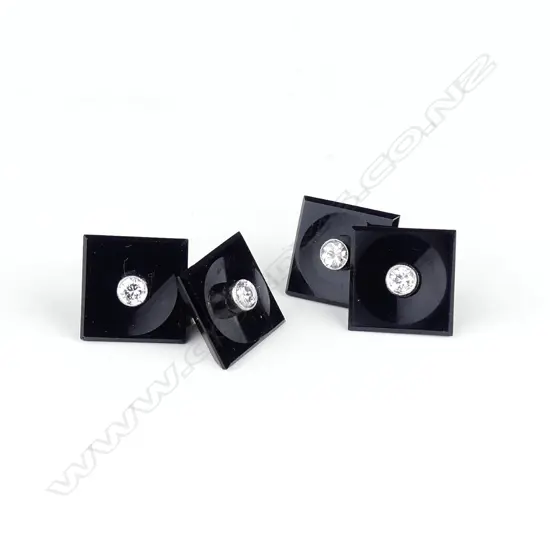 A pair of platinum onyx and diamond cufflinks