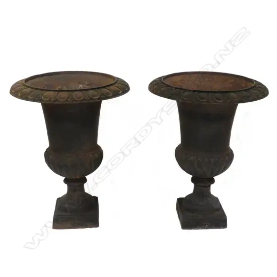 A pair of vintage cast iron garden urns