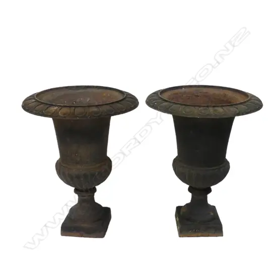 A pair of vintage cast iron garden urns