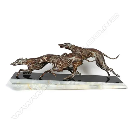 An Art Deco animalia group of three racing hounds