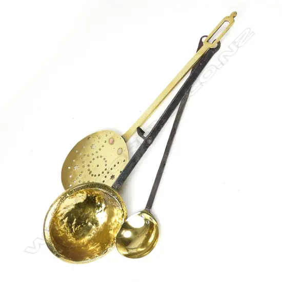 A brass cream skimmer