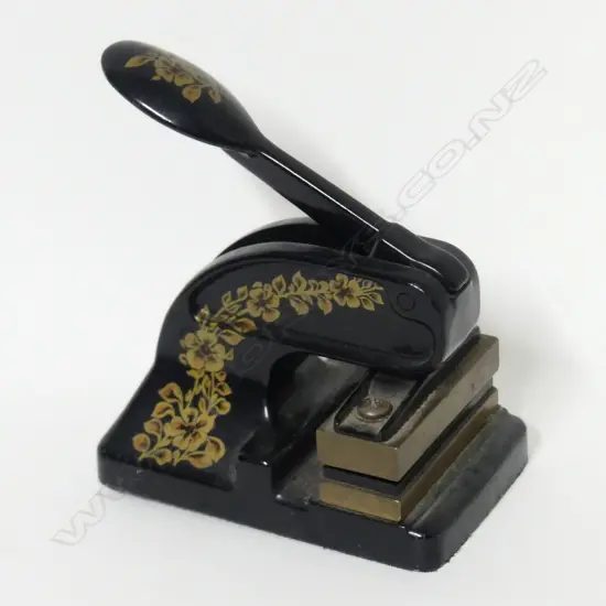 A vintage metal French desktop monogram embosser