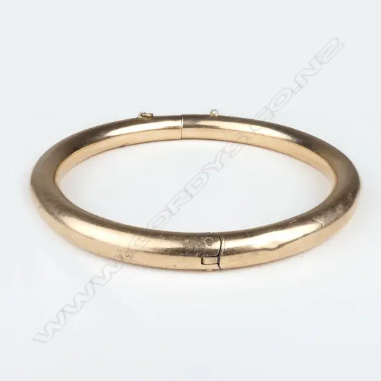 A 1920's rose gold hinged bangle
