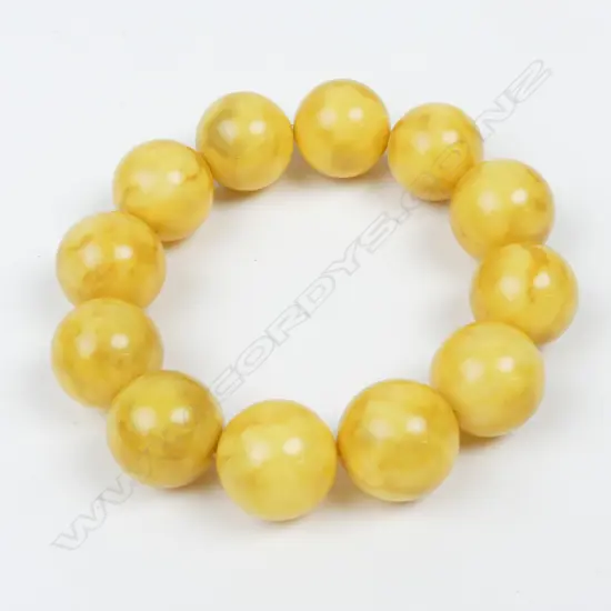 An 'egg yolk' amber bead bracelet
