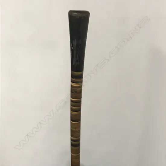 A slender walking cane of variously toned horn tapering discs