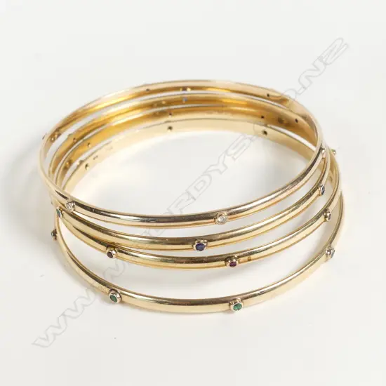 A set of four 9ct gold gem set bangles