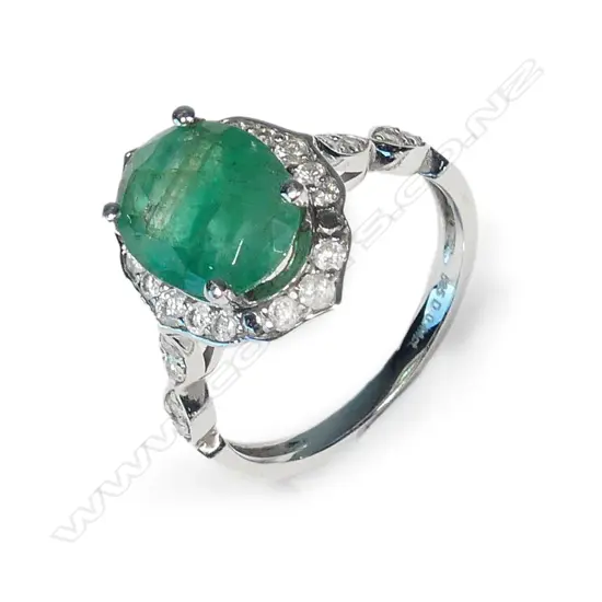 A 14ct white gold emerald and diamond dress ring
