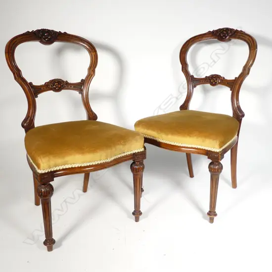A pair of Victorian walnut balloon back side chairs