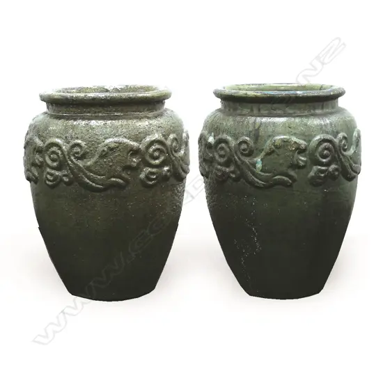 A pair of large lustrous green salt glazed garden pots
