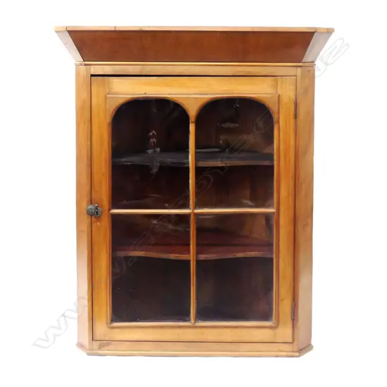 A George III mahogany hanging corner cabinet