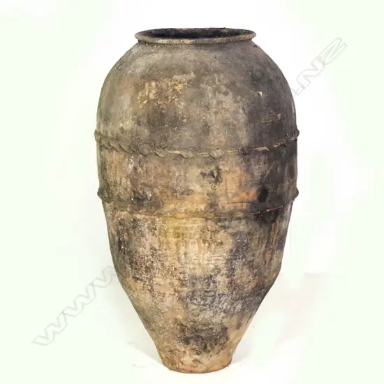 An old European terracotta tall olive oil storage jar